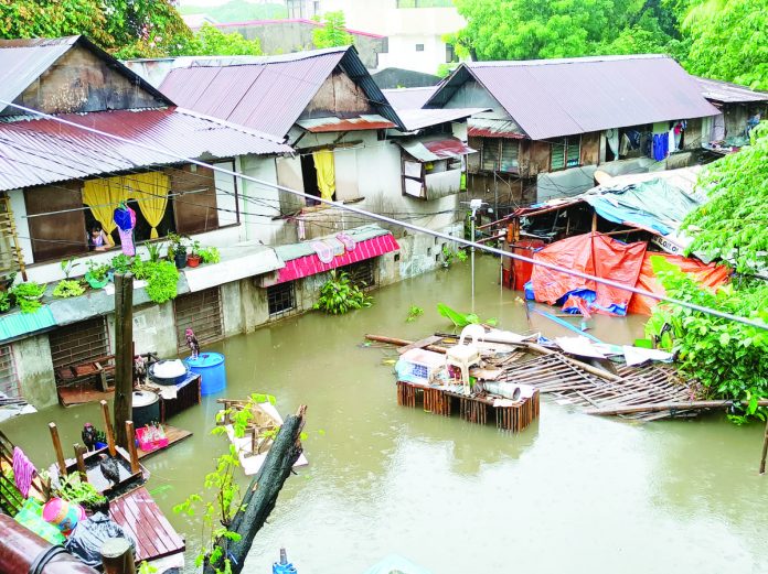 Murky floodwaters engulf houses in Barangay Desamparados, Jaro, Iloilo City following heavy rains brought by the southwest monsoon or “habagat” on Thursday, June 1. AJ PALCULLO/PN