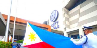 Security guards of SM City Iloilo get ready to raise the Philippine flag in front of the mall in line with the celebration of the 125th Philippine Independence Day on Monday, June 12.