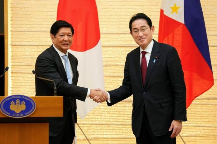 Japanese Prime Minister Fumio Kishida (right) shakes hands with Philippine President Ferdinand Marcos Jr. during a press conference in Tokyo on Feb. 9, 2023. KIMIMASA MAYAMA/POOL/AFP