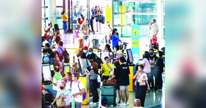 Travelers line up at airline counters to process their travel documents at the Ninoy Aquino International Airport Terminal 3 in Pasay City. JONATHAN CELLONA/ABS-CBN NEWS PHOTO