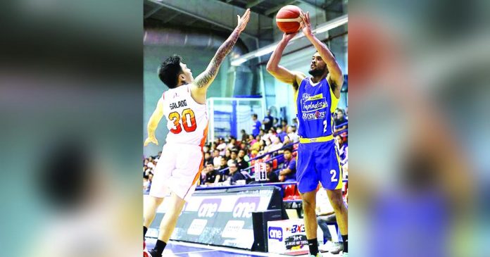 Magnolia Chicken Timplados Hotshots’ Jerrick Ahanmisi shoots over the defense of NorthPort Batang Pier’s Michael Salado. PBA PHOTO