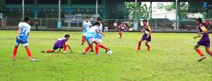 Members of Western Visayas elementary boys football team take control of the ball during their clash with the Region 9 football team at the Don Bosco Technological College in Cebu City.