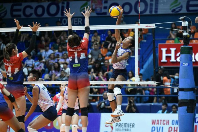 Negrense Bernadeth Pons of Creamline Cool Smashers goes for an attack against the defense of Quezon City Gerflor Defenders’ Jannine Navarro. PVL PHOTO