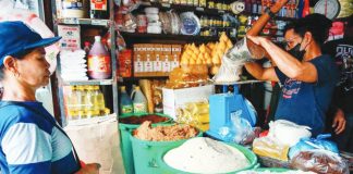 A store worker attends to a customer buying sugar at a stall in Bagong Silang public market in North Caloocan. JONATHAN CELLONA/ABS-CBN NEWS PHOTO