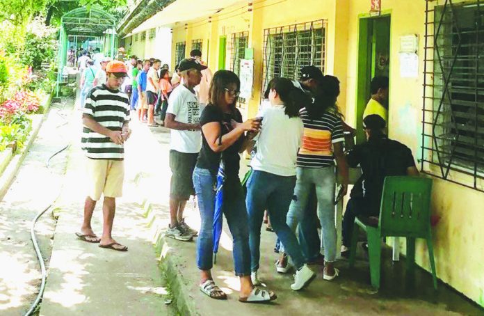 Member-consumer-owners of Central Negros electric Cooperative (Ceneco) queue to vote on the first day of plebiscite on Saturday, June 24, to ratify the joint venture agreement between Ceneco and Primelectric Holdings, Inc./Negros Electric Power Corporation