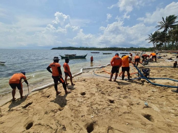 Coast Guard District Western Visayas personnel conduct flushing and flooding of contaminated sand in Caluya, Antique. The Inter-Agency Task Force created to address the oil spill said initiatives yielded positive results but is yet to declare a ‘total cleanup’. COAST GUARD DISTRICT WESTERN VISAYAS PHOTO