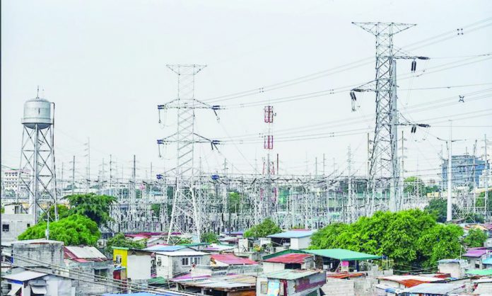 High-voltage towers that support transmission lines for electrical power distribution in the Luzon grid is seen from a residential area in Baesa, Quezon City. MARIA TAN, ABS-CBN NEWS/FILE PHOTO