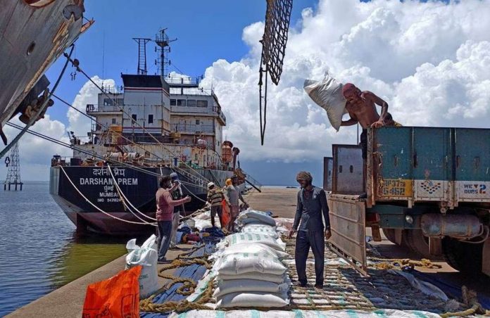 Laborers unload rice bags from a supply truck at India's main rice port at Kakinada Anchorage in the southern state of Andhra Pradesh, India. India accounts for more than 40 percent of all global rice shipments. REUTERS/RAJENDRA JADHAV FILE PHOTO