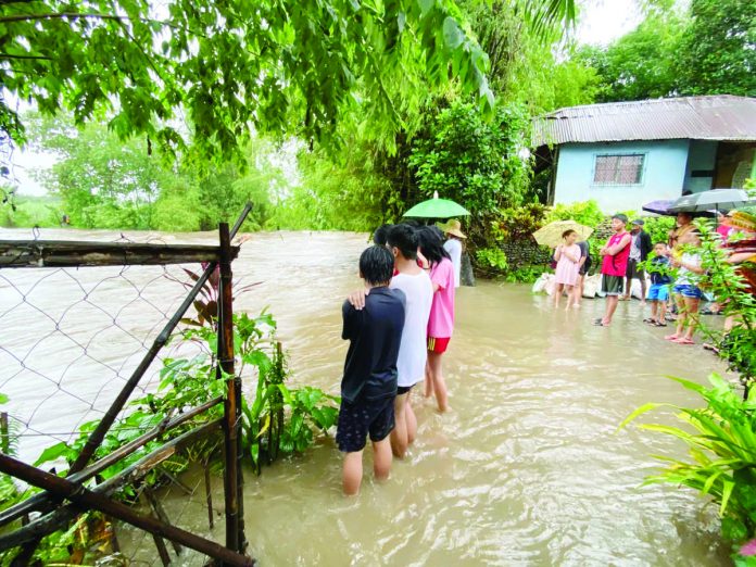 Residents of Barangay Ma-ao, Bago City wait for the flood to subside. The city is among the local governments in Negros Occidental affected by the inclement weather. BARANGAY MA-AO COMMUNITY FACEBOOK PHOTO