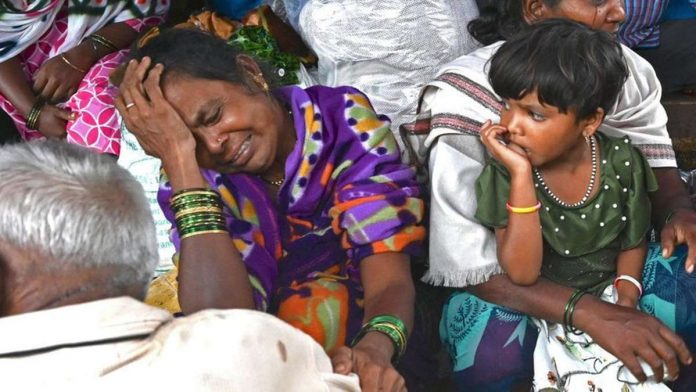 Relatives of people who lost their lives in a landslide weep in a house at Irshalwadi village in Raigad district of India's Maharashtra state. GETTY IMAGES