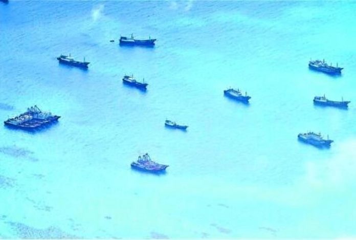 WHERE’S THE FISH? A cluster of Chinese vessels is seen at Del Pilar (Iroquois) Reef on June 30. Pilots who took this photo noted that while they appeared to be fishing boats, they just lingered in the area and hardly engaged in any fishing activity. AFP WESCOMPHOTO