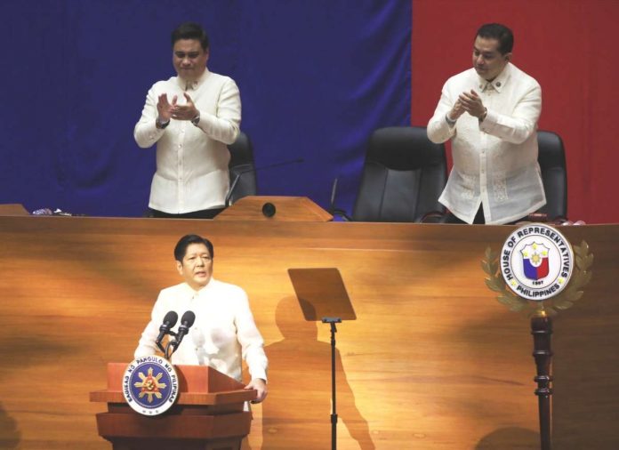 VITAL MEASURES. President Ferdinand “Bongbong” Marcos Jr. urged Congress to pass priority measures of his administration, during his first State of the Nation Address at the Batasang Pambansa Complex in Quezon City on July 25, 2022. Standing behind him are Senate President Juan Miguel Zubiri (left) and House Speaker Martin Romualdez. PNA PHOTO