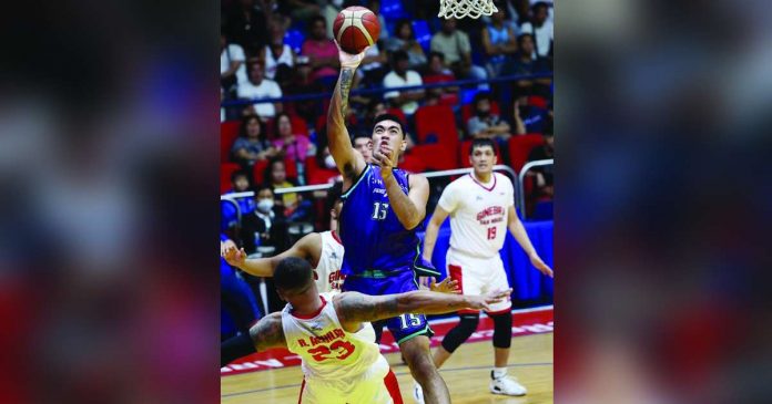 Converge FiberXers’ Justin Arana charges to the defense of Barangay Ginebra San Miguel Kings’ Raymond Aguilar for an inside shot. PBA PHOTO