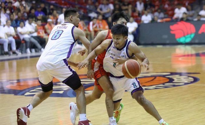 Converge FiberXers’ playing assistant coach McJour Luib uses the screen of teammate Barkley Ebona to get away from his NorthPort Batang Pier defender. PBA PHOTO