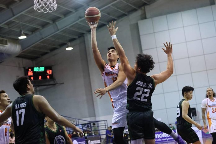 NorthPort Batang Pier’s Arvin Tolentino scores a floater against the defense of Terrafirma Dyip’s Javi Gomez de Liano. PBA PHOTO