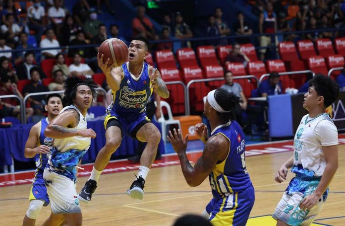 Magnolia Chicken Timplados Hotshots’ Jiovani Jalalon sits on the air as he goes for a layup.