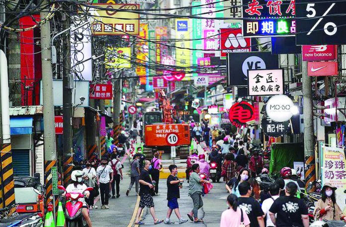 People walk on the street in New Taipei City, Taiwan. EPA-EFE/RITCHIE B. TONGO/FILE PHOTO