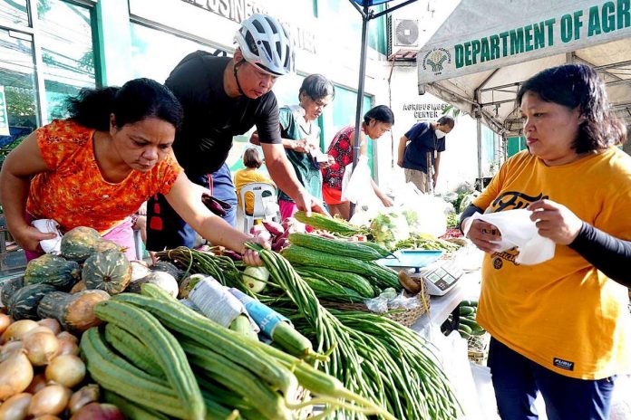 Consumers buy fresh vegetables at the Agripreneur Cooperative Kadiwa stall inside the Department of Agriculture-Agribusiness Development Center in Elliptical Road, Diliman, Quezon City. Are their wages enough to make purchases?