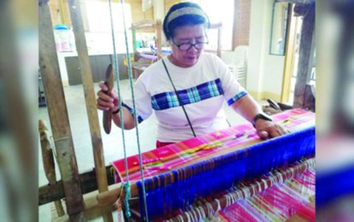 A loom weaver of the Bagtason Loomweavers Association (BLWA) in Bugasong, Antique weaves a piece of patadyong cloth. BLWA chairperson Mario Manzano says a weaving center will be constructed in the municipality of San Remigio this July. PNA PHOTO BY ANNABEL CONSUELO J. PETINGLAY