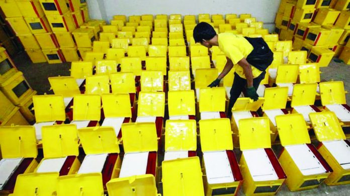 Commission on Elections (Comelec) Region 6 director Dennis Ausan (inset) says they are expecting this week the arrival of ballot boxes for the Barangay and Sangguniang Kabataan Elections. File photo shows a Comelec personnel inspecting ballot boxes in Metro Manila. ABS-CBN NEWS/FILE PHOTO