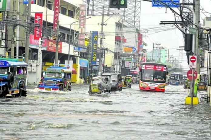 A combination of high tide and heavy rains brought about by Typhoon “Egay” resulted in this situation in one of Dagupan City’s commercial areas on Saturday. A total of 31 barangays in the city were flooded and at least 245 families were forced to evacuate, officials said. Photo by WILLIE LOMIBAO / Inquirer Northern Luzon