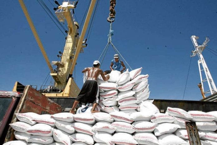 Around 300,000 metric tons of rice will arrive this month and in September in the country. File photo shows workers unloading sacks of rice from the Vietnam cargo ship in the port of Tabaco, Albay. INQUIRER FILE PHOTO