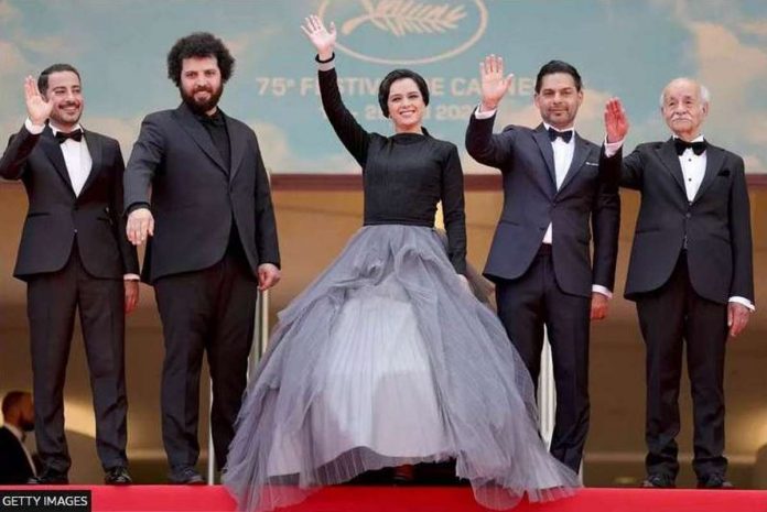 Saeed Roustaee (second left) with the cast of “Leila’s Brothers” on the red carpet in Cannes in May 2022. GETTY IMAGES