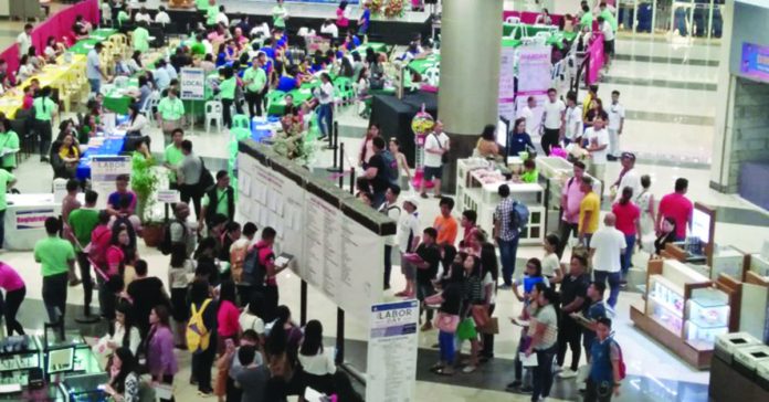 Job seekers flock at the job fair held at the Robinsons Place Jaro in Iloilo City in this file photo. PNA PHOTO BY PERLA LENA