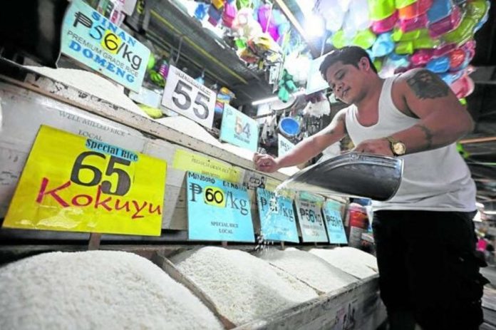 A rice stall owner at Kamuning public market in Quezon City checks his stock as he waits for buyers. PHOTO BY GRIG C. MONTEGRANDE / PHILIPPINE DAILY INQUIRER