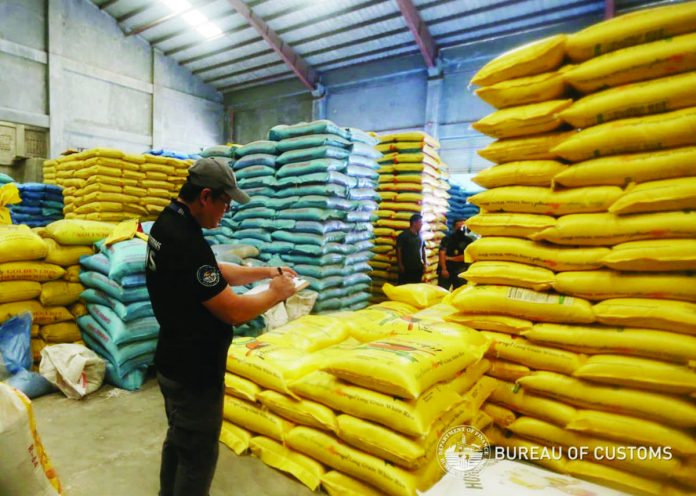 The Bureau of Customs leads the inspection of rice warehouses in Intercity Industrial Complex in San Juan, Balagtas, Bulacan on Aug. 24. They recovered about 202,000 sacks of imported rice grains from Vietnam, Cambodia and Thailand. BUREAU OF CUSTOMS PHOTO