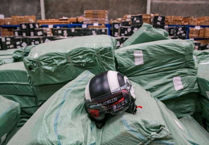 Fake shoes and motorcycle helmets without proper ICC stickers are being checked during an inspection conducted by representatives of Bureau of Customs and Department of Trade and Industry at a warehouse on Toclong-San Sebastian road in Kawit, Cavite on April 6, 2022. JONATHAN CELLONA/ABS-CBN NEWS PHOTO