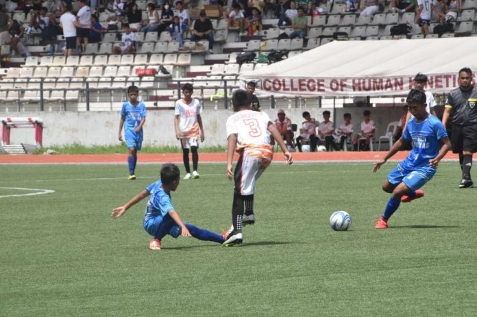 Western Visayas elementary boys football team’s Drystan Alexandrae Delgado-Torres (right) prepares to kick the ball during their 2023 Palarong Pambansa gold medal match against Northern Mindanao. PHOTO COURTESY OF DEPED TAYO WESTERN VISAYAS REGION