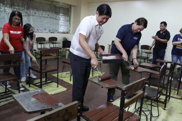 President Ferdinand “Bongbong” Marcos Jr. (left) and Vice President Sara Duterte paint classroom chairs as part of Brigada Eskwela 2023 at Victorino Mapa High School in Barangay San Miguel, City of Manila on Monday, Aug. 14, 2023. PHOTO FROM RTV MALACAÑANG