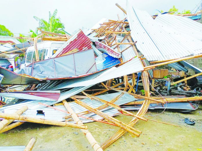 Two workers were hurt, and nine cars were damaged when a tornado ripped through Barangay Tagbak, Jaro, Iloilo City yesterday morning, Aug. 30. AJ PALCULLO/PN