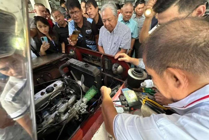 Transport secretary Jaime Bautista witnesses the demonstration of 3 Filipino inventions meant to save fuel and reduce carbon emissions at the Land Transportation Office, Diliman, Quezon City on Aug. 25. ANDREA TAGUINES/ABS-CBN NEWS PHOTO