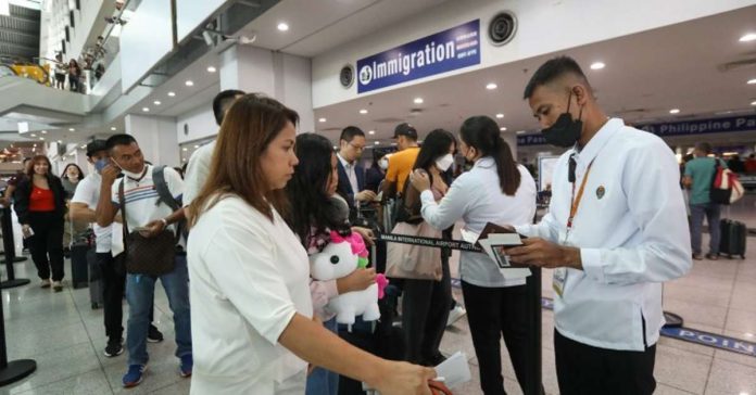 Airport personnel check the passport of passengers at the Ninoy Aquino International Airport in this undated photo. The Department of Health says arriving international travelers are now allowed entry regardless of their vaccination status for the coronavirus disease 2019. PNA PHOTO BY YANCY LIM