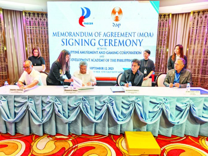 Philippine Amusement and Gaming Corporation (PAGCOR) chairman and CEO Alejandro Tengco (seated, 2nd from left) and Development Academy of the Philippines (DAP) president and CEO Atty. Engelbert Caronan, Jr. (seated, 2nd from right) lead the signing of a memorandum of agreement (MOA) between the two agencies, with the latter providing technical services in the agency's reorganization efforts. With them in photo are PAGCOR Vice President for Human Resource and Development Group Angelito Domingo (extreme left) and DAP Vice President for Mindanao Dr. Mark Lemuel Garcia (extreme right).