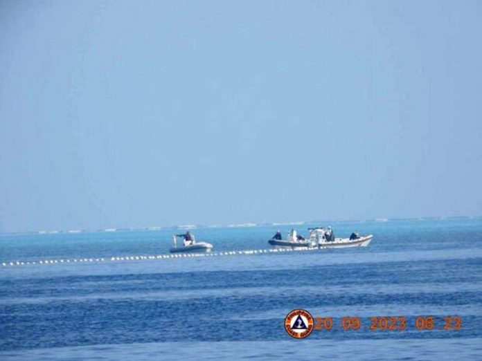 Chinese Coast Guard boats close to the floating barrier are pictured on Sept. 20, 2023, near the Scarborough Shoal in the South China Sea, in this handout image released by the Philippine Coast Guard on Sept. 24, 2023. PHILIPPINE COAST GUARD/HANDOUT VIA REUTERS