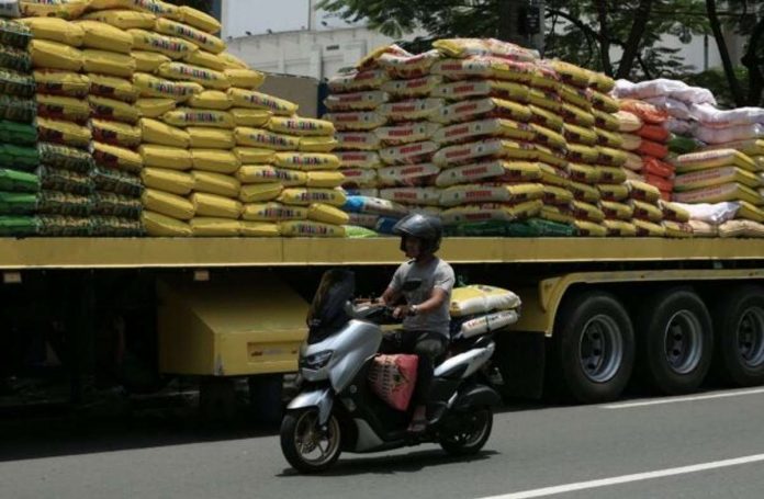 As rice prices spike, a man is seen loaded with sacks of rice on a motorcycle along Dagupan Street in Manila. Photo by RICHARD A. REYES / Philippine Daily Inquirer