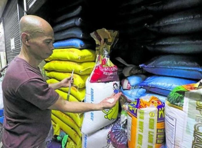 A rice retailer shows the newly harvested rice delivered to his stall in Marikina Public Market in Marikina City on Sept. 19, 2023. PHOTO BY GRIG C. MONTEGRANDE / PHILIPPINE DAILY INQUIRER