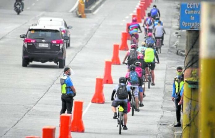 Cyclists pass through the bike lane along Edsa. Composed of six sections, the bike lanes stretch from Edsa Aurora to Magallanes southbound. INQUIRER FILE PHOTO