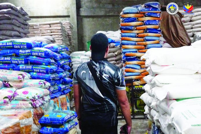 A total of 20,000 sacks of smuggled rice were seized from two warehouses in Pulang Lupa, Las Piñas and Bacoor, Cavite on Sept. 14. BOC PHOTO