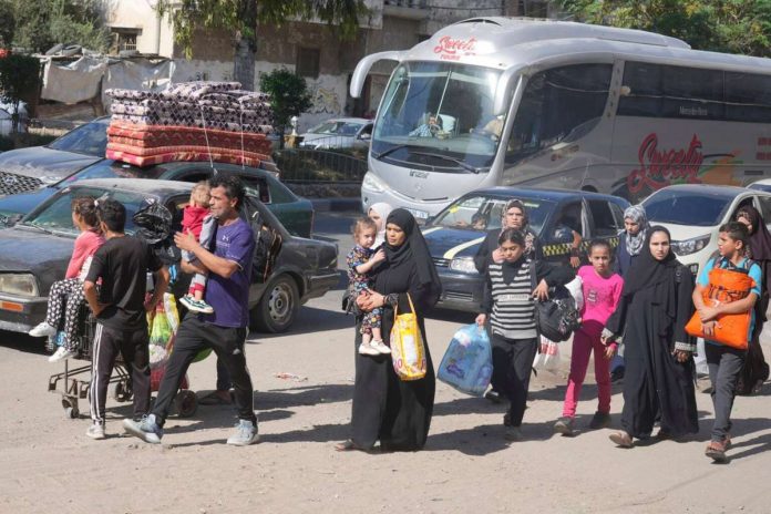 Palestinians flee to the southern Gaza Strip after the Israeli army issued an evacuation warning to a population of over one million in northern Gaza and Gaza City to seek refuge in the south ahead of a possible Israeli ground invasion, Friday, October 13, 2023. AP PHOTO/HATEM MOUSSA