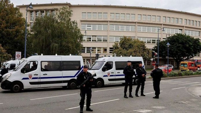 Policemen guard a school in Arras after the attack. REUTERS