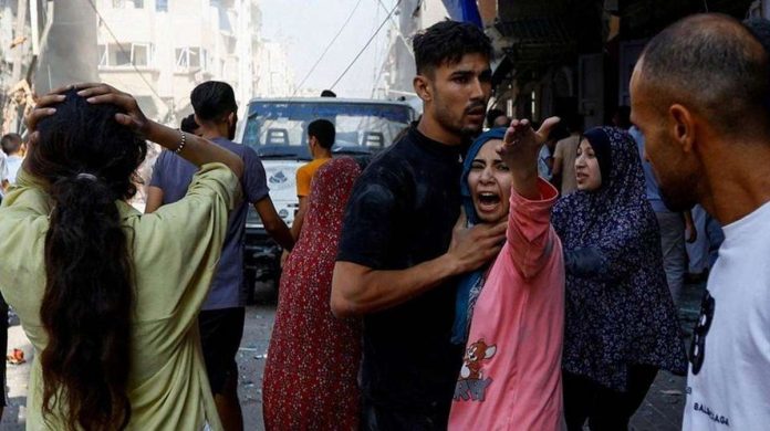 Palestinians react at the scene of an Israeli strike in Khan Younis, in the southern Gaza Strip. Several locations in Khan Younis were targeted on Tuesday. REUTERS