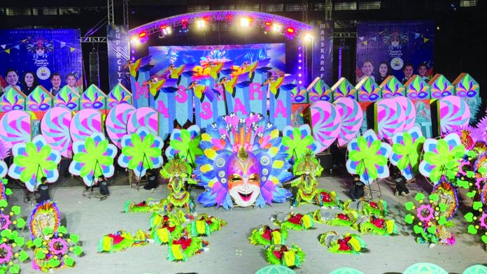 BACK-TO-BACK. Defending its crown, Barangay Granada is again hailed the 2023 MassKara street and arena dance competition champion. Photo shows dancers of Barangay Granada in their vibrant costumes during yesterday’s performance at the Paglaum stadium. DR. RONNIE BALDONADO PHOTO