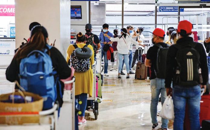 Overseas Filipino workers are assisted by members of the Overseas Workers Welfare Administration and the Philippine Coast Guard at the arrival lobby of the Ninoy Aquino International Airport Terminal 1 in Pasay City in this file photo. PHOTO COURTESY ABS-CBN NEWS