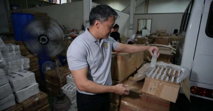 Bureau of Internal Revenue (BIR) commissioner Romeo Lumagui Jr. leads the nationwide raid of excisable perfume and toilet water products on Sept. 27 and 28. BIR seized almost 400,000 bottles of perfume and toilet water from over 400 firms with P604.3 million in tax liabilities. BIR PHOTO