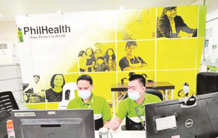 Photo of PhilHealth office in Region XI with a tarpaulin sign carrying the PhilHealth logo in the background. PHOTO FROM PHILHEALTH REGION XI FACEBOOK PAGE