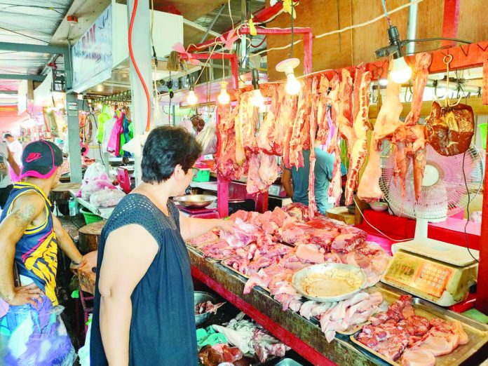 Pork cuts are on sale at a public market in Iloilo. The Department of Agriculture says demand for pork increases during the holidays. PN PHOTO